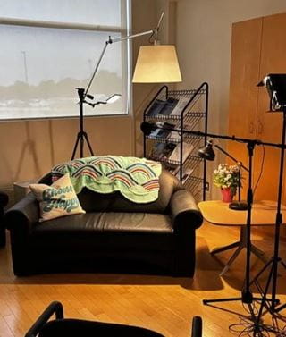 Sofa with a lamp hanging over it