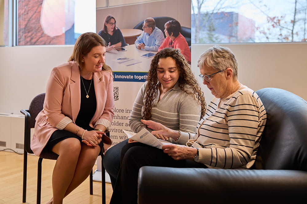 Three women reading a pamphlet