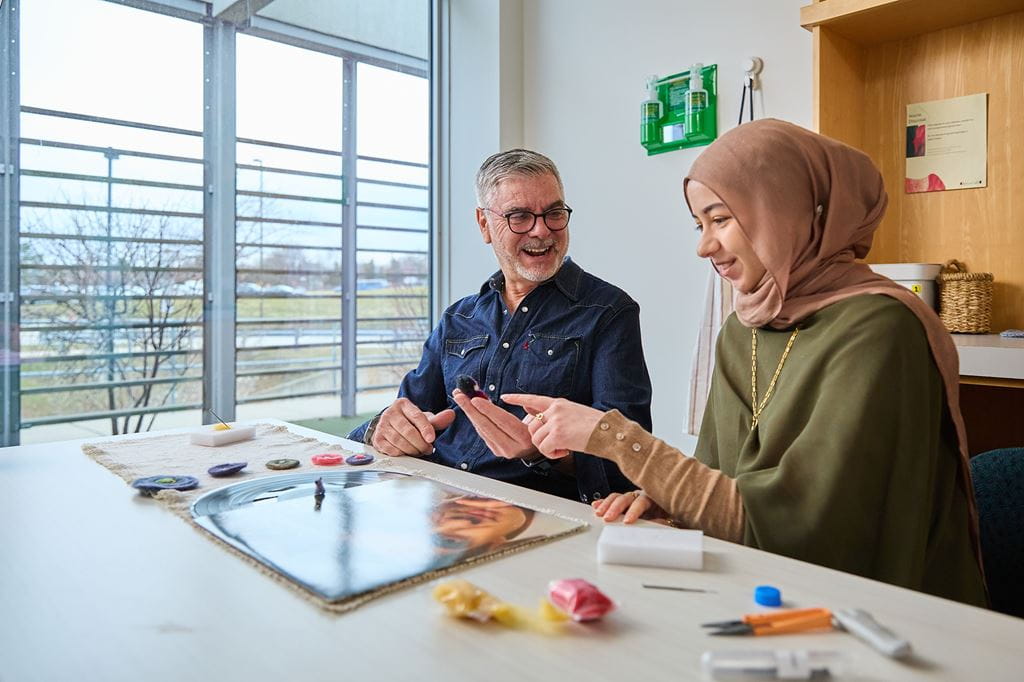 Two people working on an art project