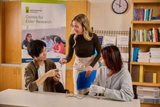 A teacher speaking to two students