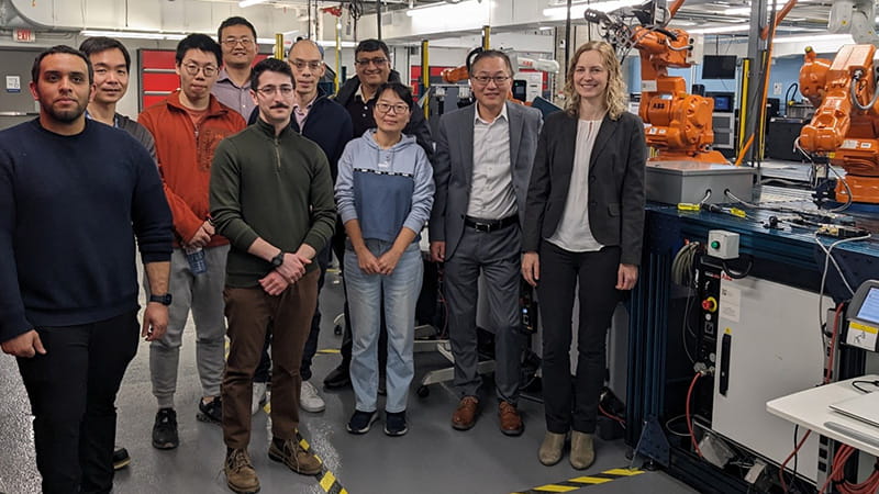 Group gathered for a photo in a robotics lab