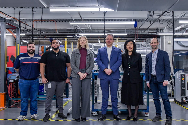 Six people standing side-by-side and posing for a photo