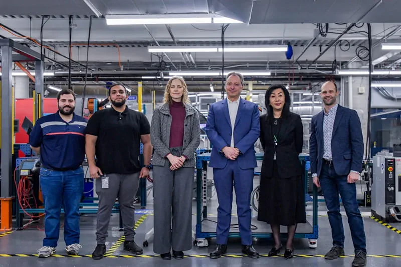 Six people standing side-by-side and posing for a photo