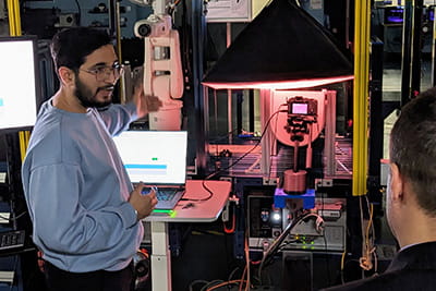 A person providing a demonstration of a robotic imaging system