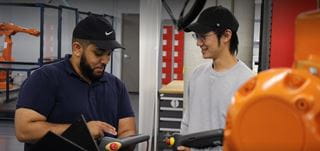 Two people working in a robotics lab