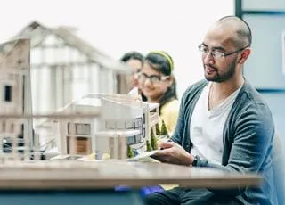 Sheridan Architectural Technology students with a model of a house