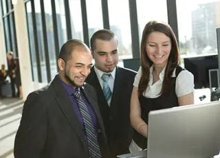 Advertising-Marketing Communications students looking at a computer