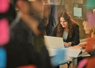 Advertising-Marketing Communications students looking at a computer