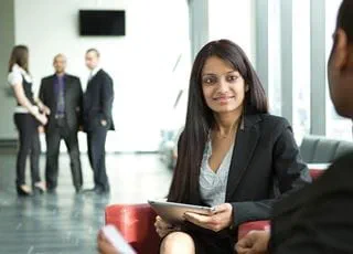 Woman holding a tablet conducting a meeting