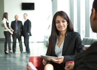 Woman holding a tablet conducting a meeting