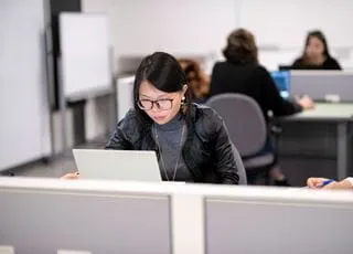 A person working on a computer in a computer lab