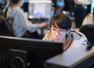 A person working on a computer in a computer lab