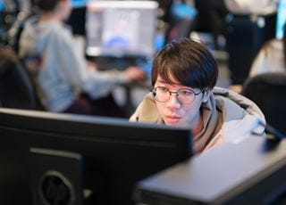 A person working on a computer in a computer lab