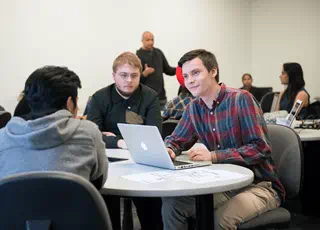 Computer Systems Analyst students working on a computer