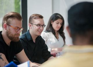 A closeup of a small group of students sitting together