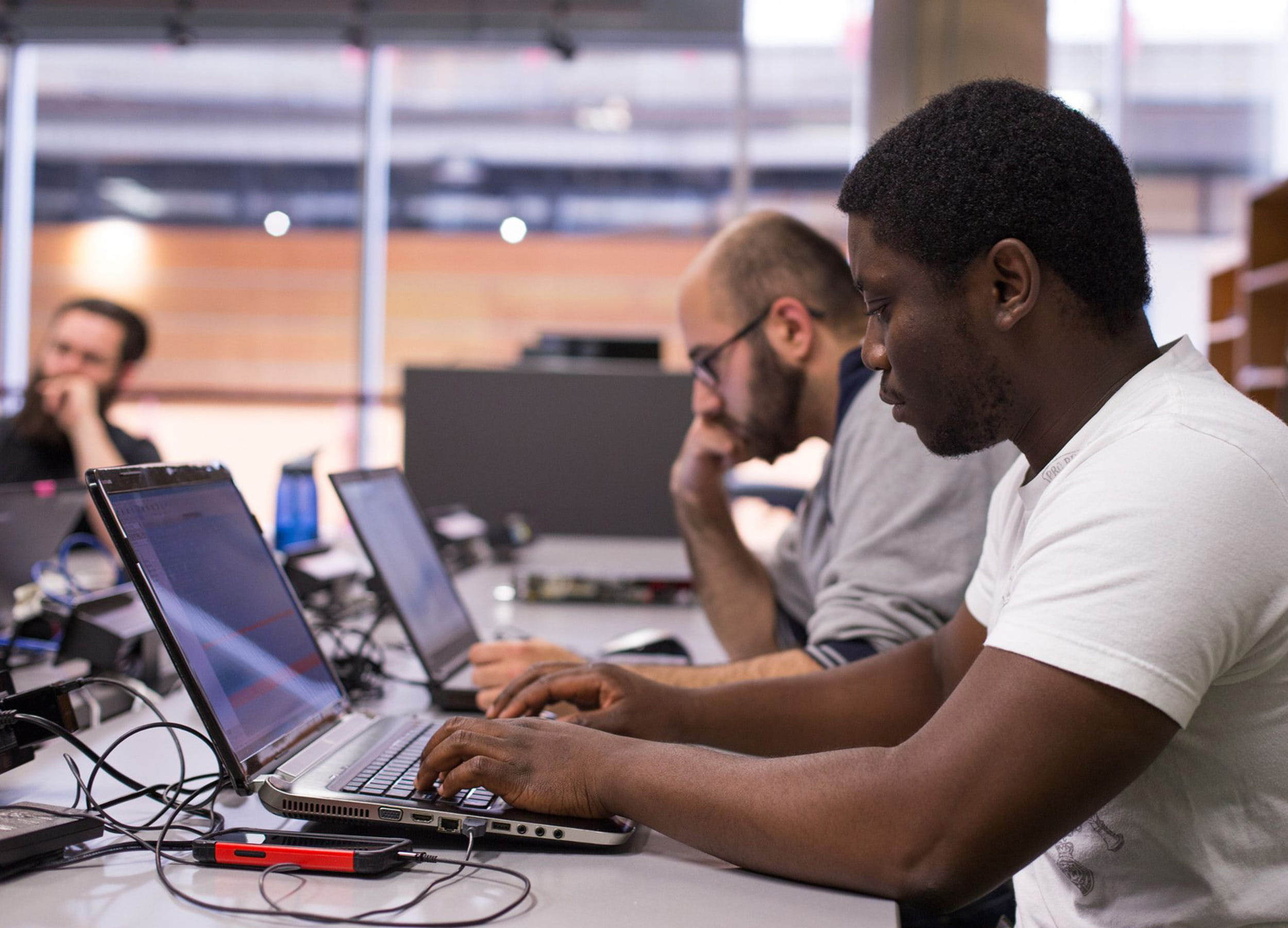 Students working in a computer lab on laptops