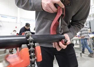 Mechanical Techniques student working with plumbing equipment