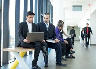 Paralegal students looking at a laptop