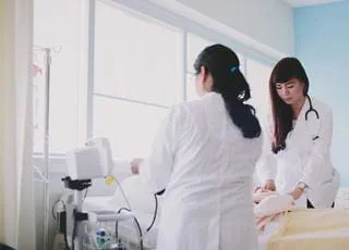 Practical nursing students with a patient in a hospital