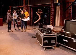 Technical production students working in a TV control room