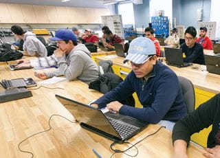 Technology fundamentals students working on laptops