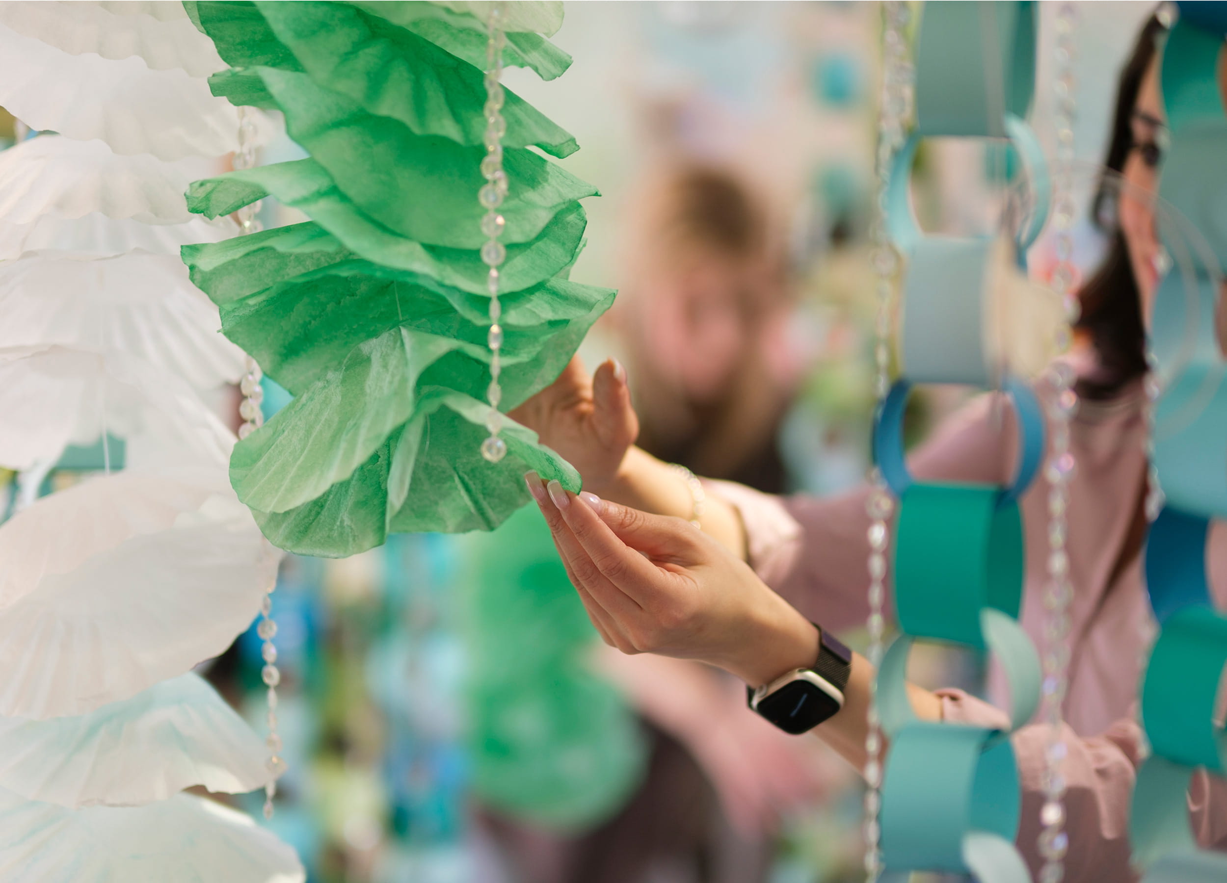 A Visual Merchandising Arts student setting up a display window