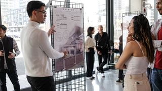 Student presenting work at an exhibit