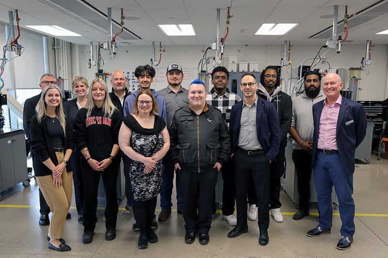 Group posing in a skilled trades lab